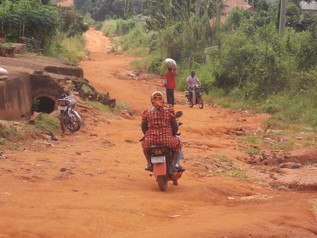 villagers struggling through one of the unmotorable roads in the local government